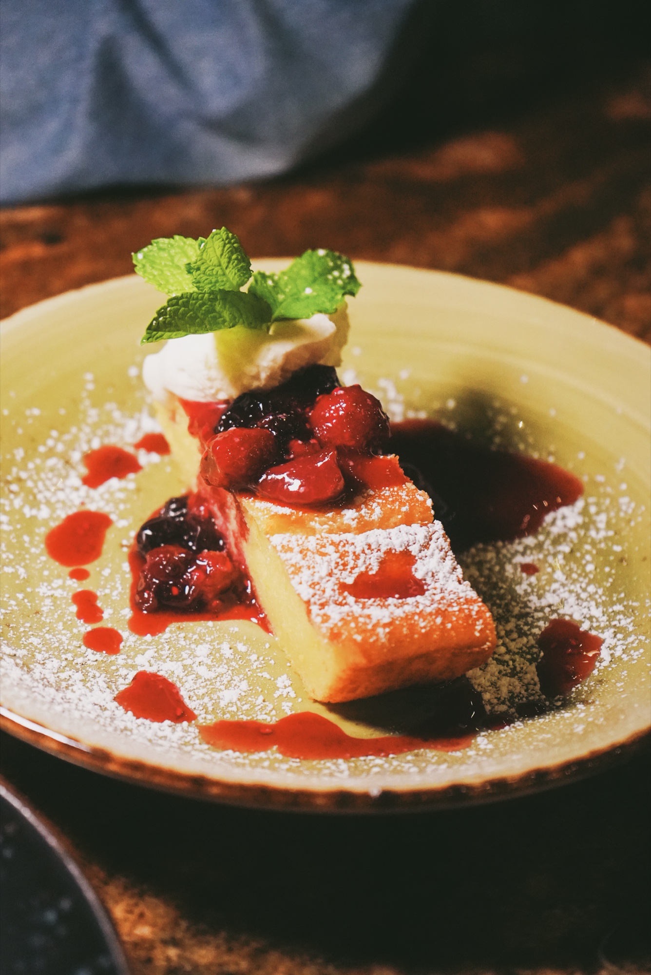 Golden French toast with berry compote and powdered sugar at weekend brunch at Tin Roof Bistro