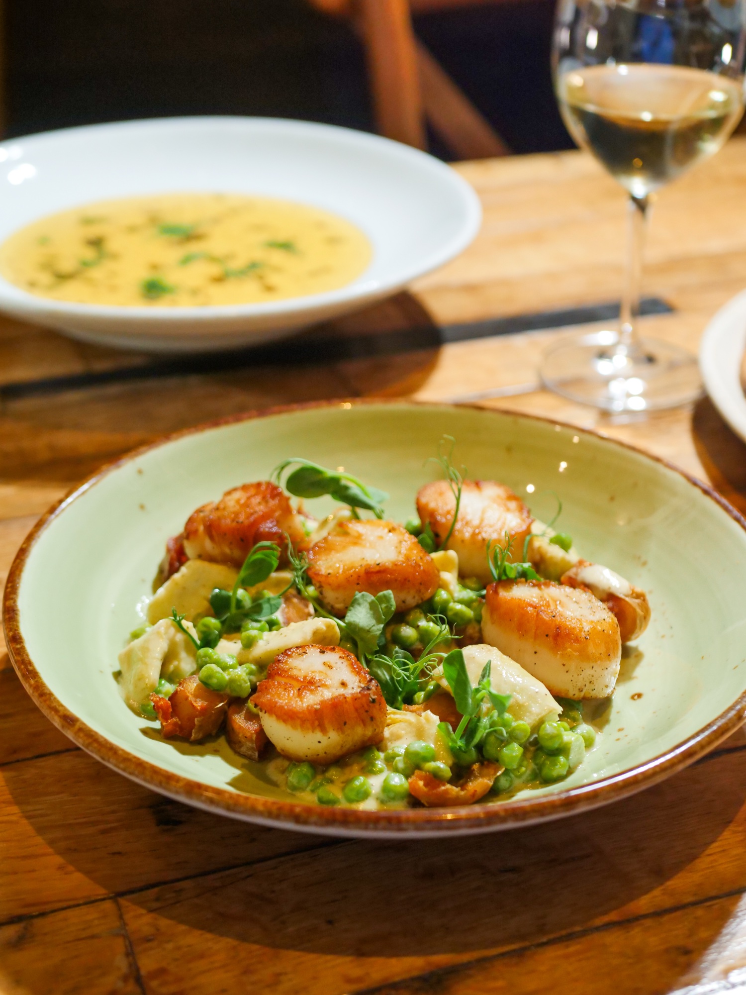 Pan-seared sea scallops over saffron celery root purée at Tin Roof Bistro