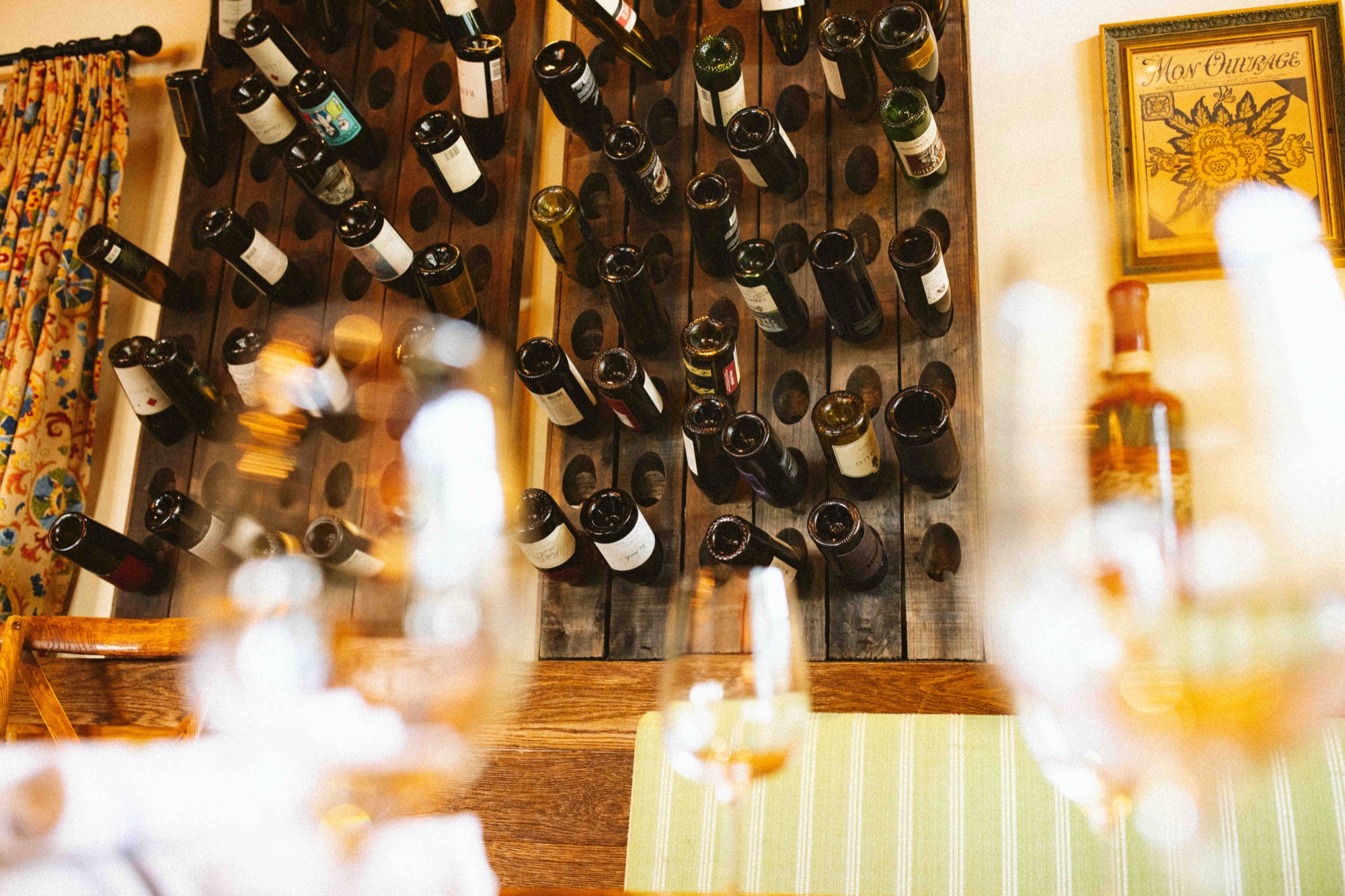 A floor-to-ceiling wine bottle display in the dining room at Tin Roof Bistro